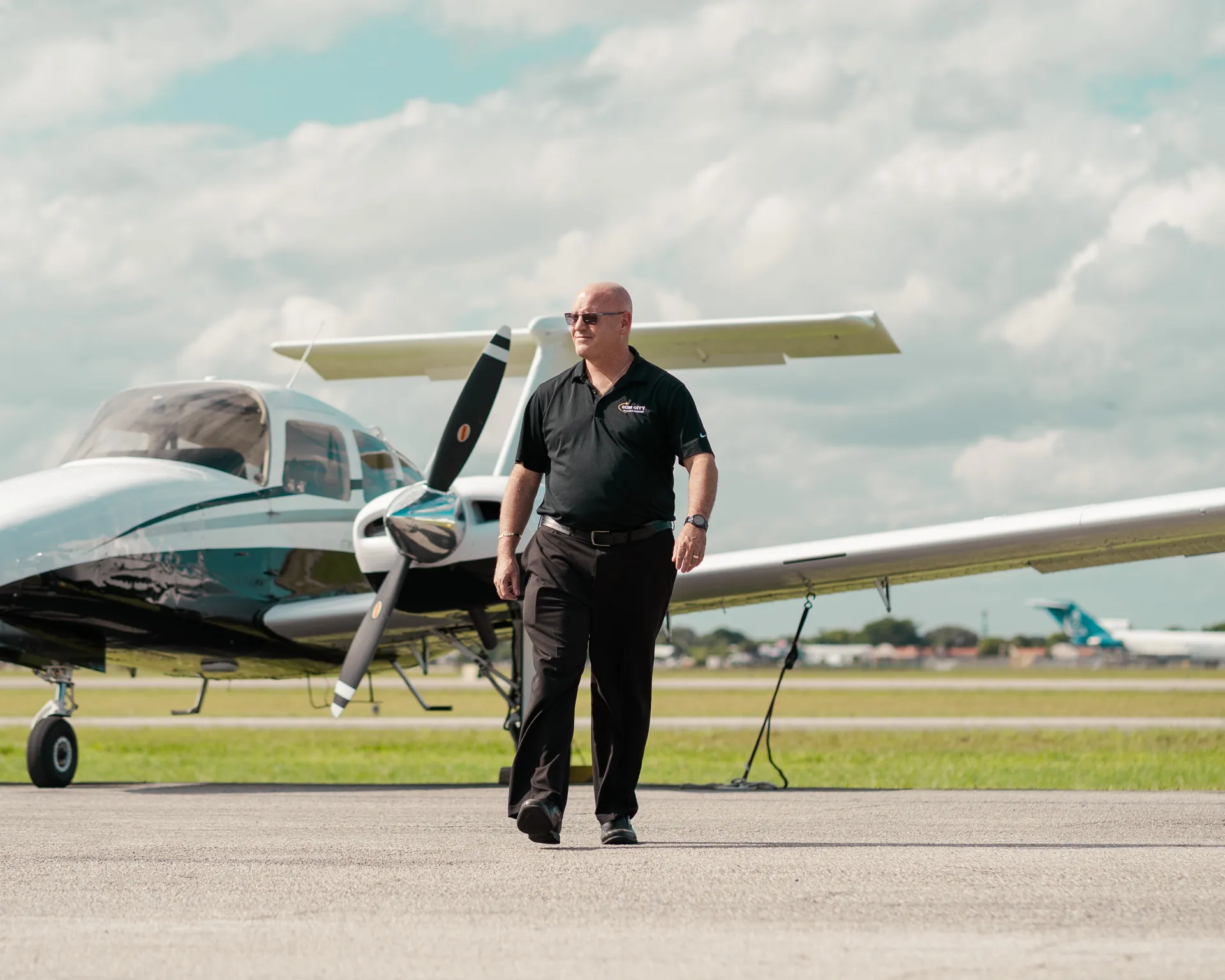 sun city aviation academy cool pilot in front of a plane at the airport