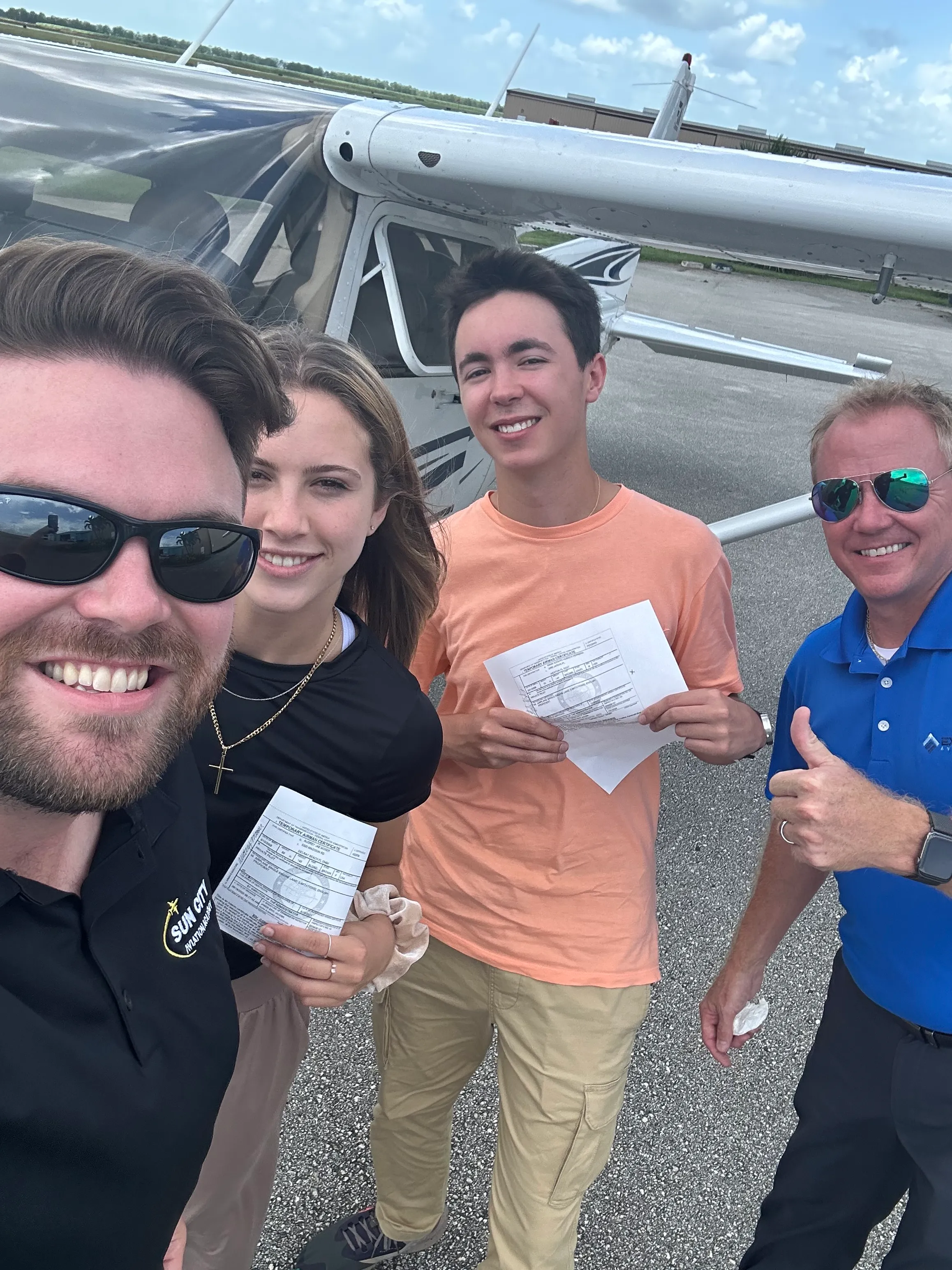 sun city aviation academy student and flight instructor celebrating after passing a checkride