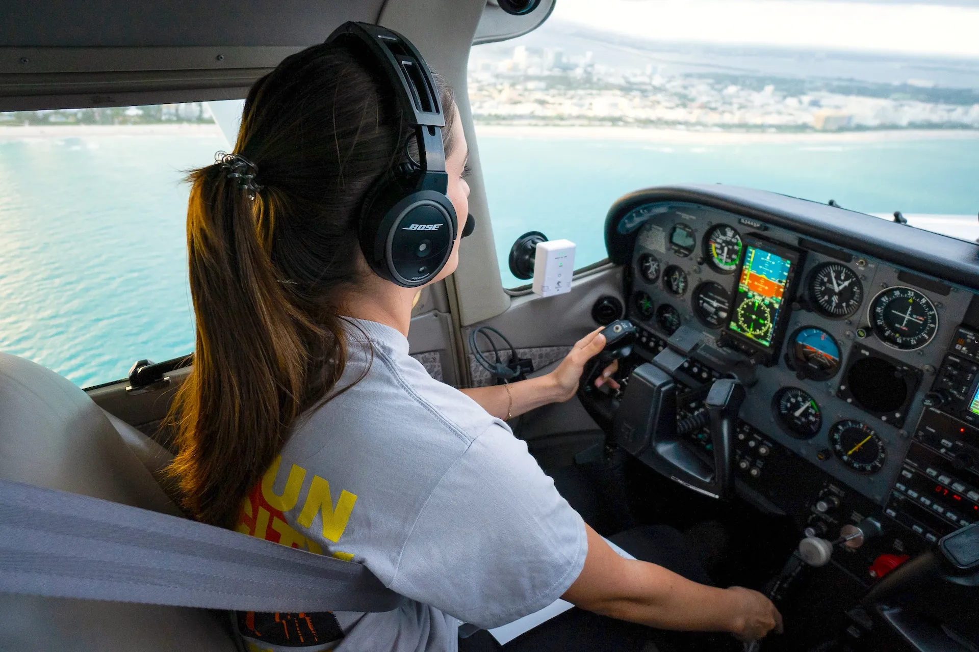 Sun City Aviation Academy commercial flight student and instructor in cockpit over South Florida