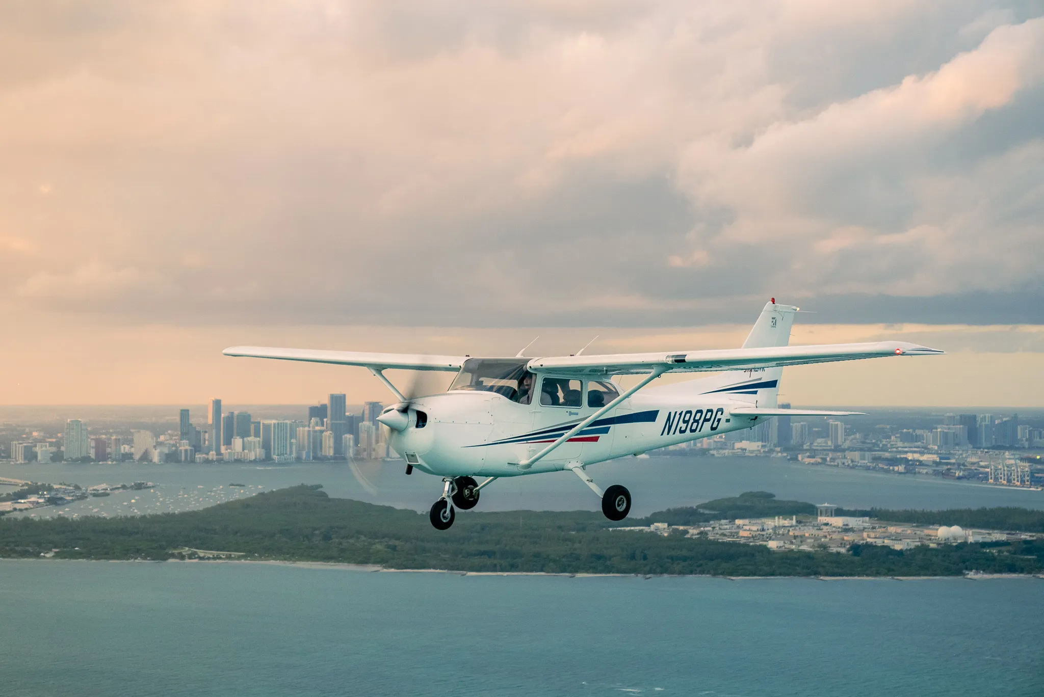 Sun City Aviation Academy Cessna aircraft in flight over South Florida waterways