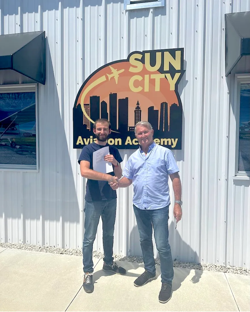sun city aviation academy student and flight instructor celebrating after passing a checkride