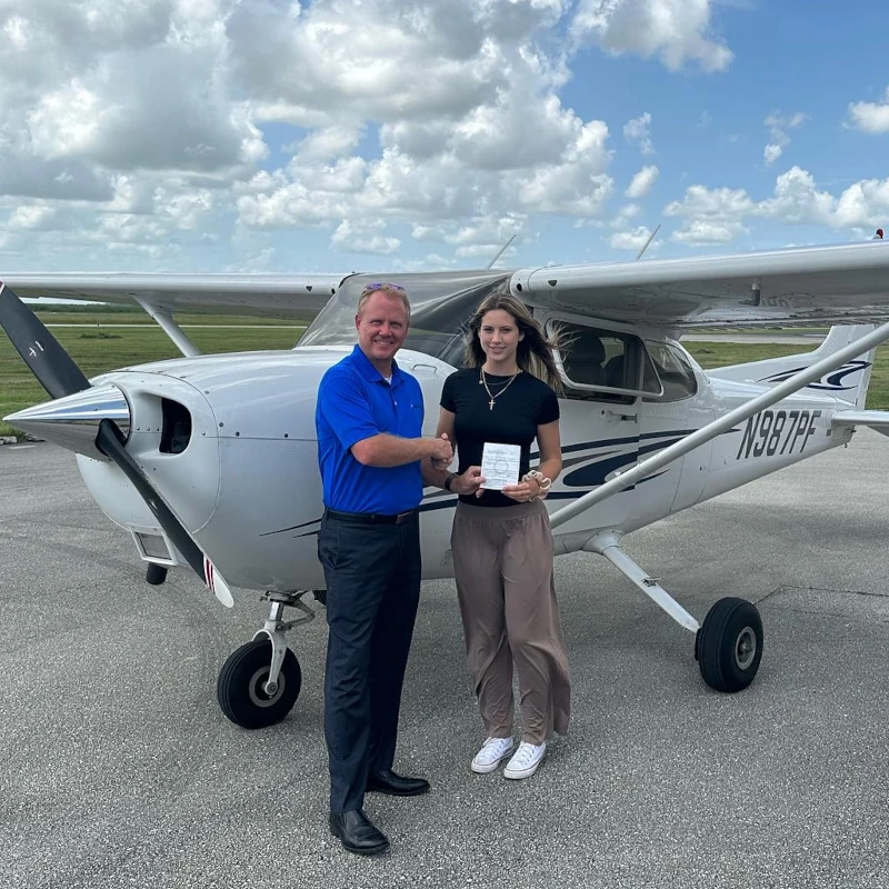 sun city aviation student and flight instructor celebrating after passing a checkride