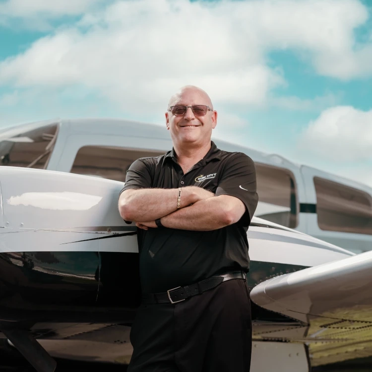 Sun City Aviation Academy cool pilot in front of a plane at the airport