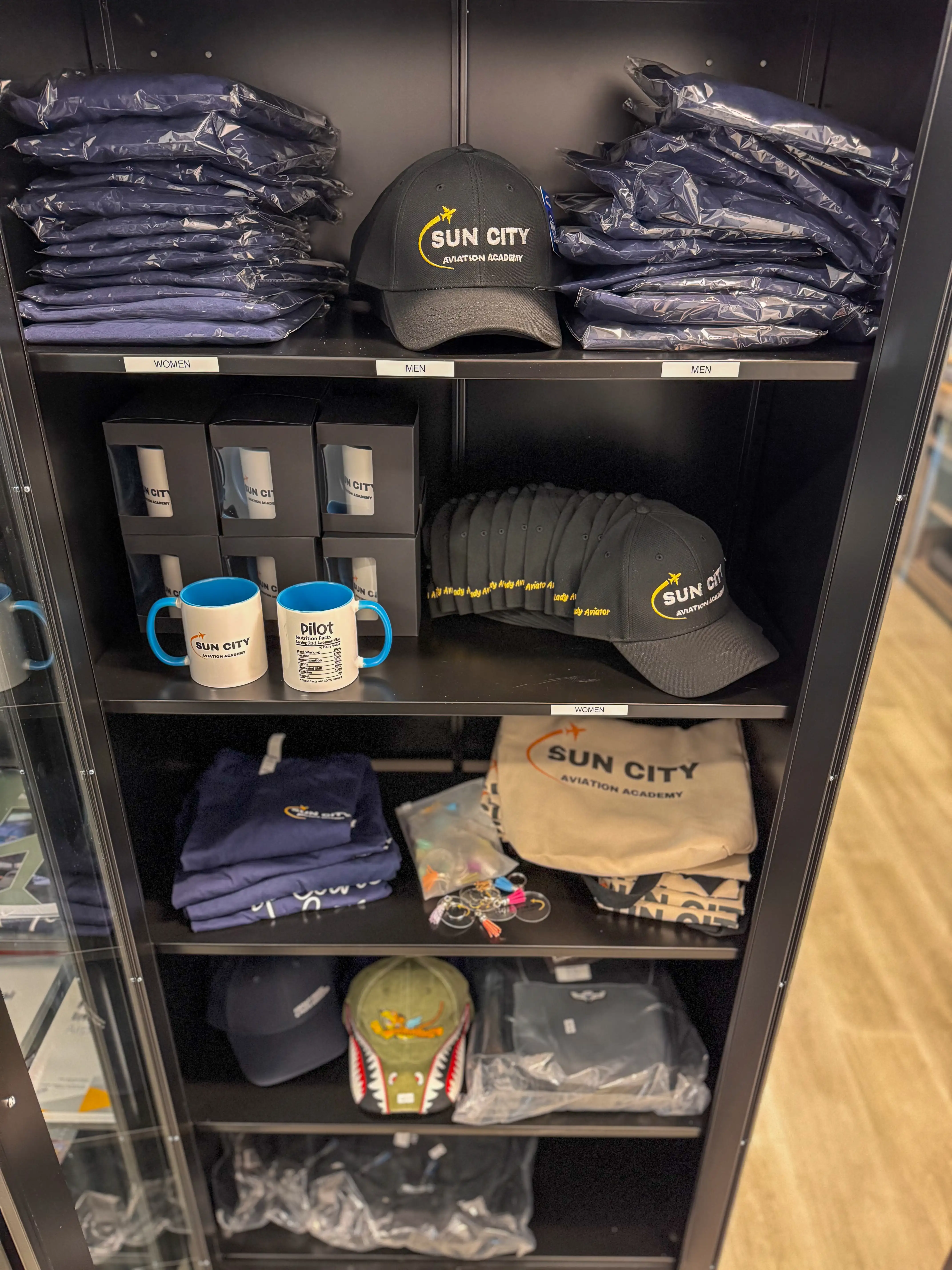 Sun City Aviation branded shirts and caps on display
