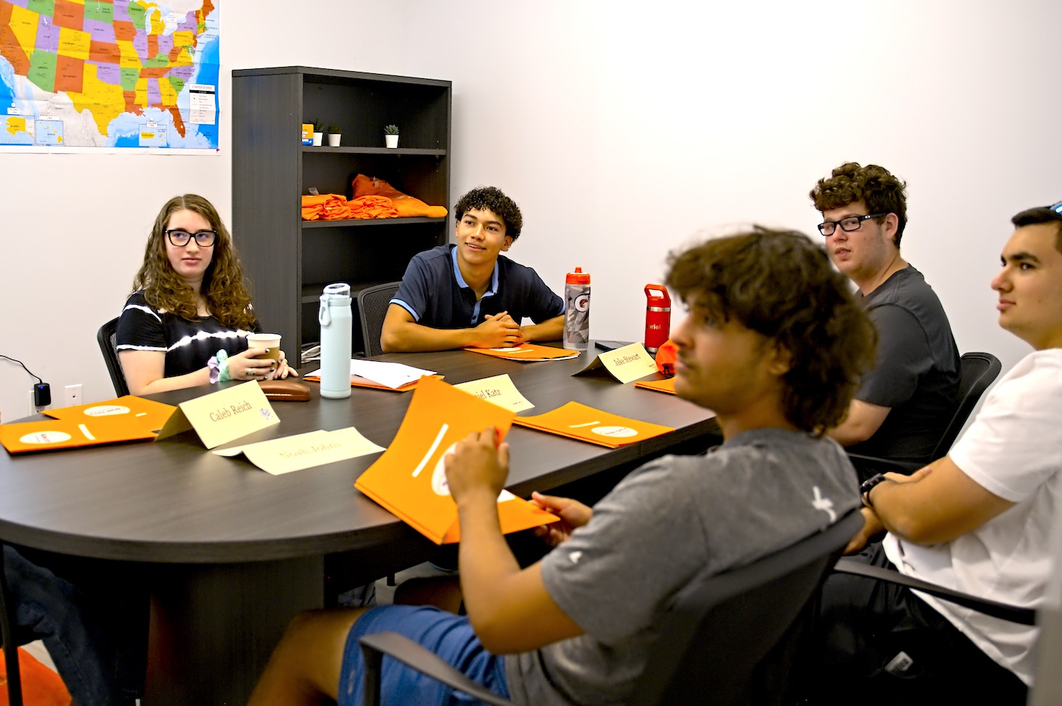 Students discussing flight training instructions at Sun City Aviation Academy