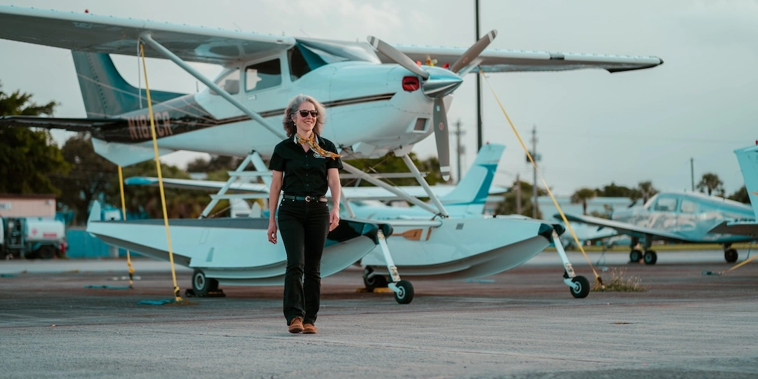 Sun City Executive Business Manager, Georgette Poulos, with our seaplane at North Perry Airport