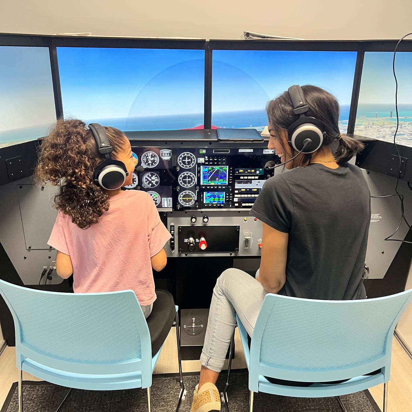Sun City Aviation Academy Redbird simulator, flight instructor and young girl flying